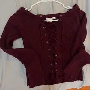 Ruby and Jenna burgundy sweater with lace-up detail.
